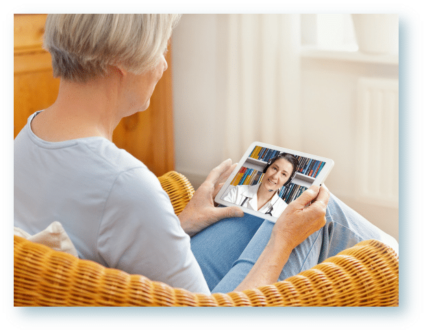 Woman at home meeting with her audiologist through telehealth, a virtual hearing appointment